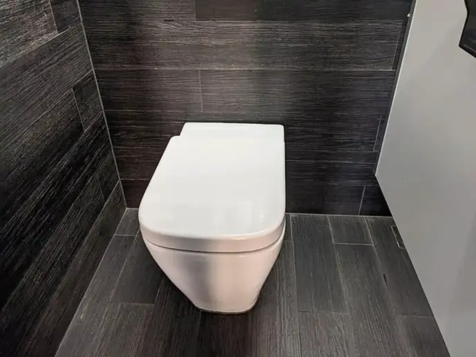 Porcelain toilet with a vitreous china enamel coatin.