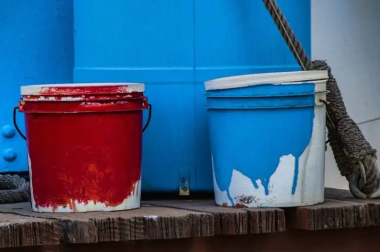 Two buckets of paint.
