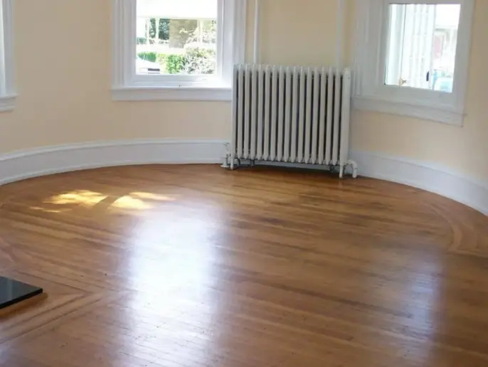 Round room with wooden floor.