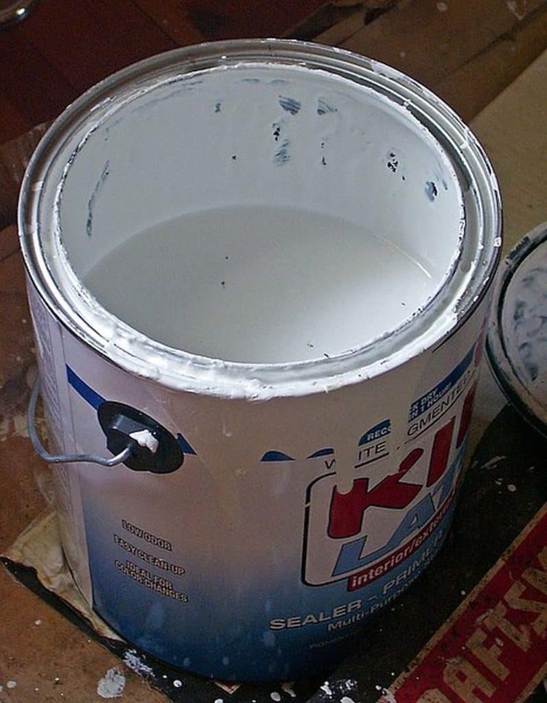 Open bucket of kilz primer.