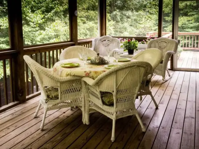 Wooden patio with tables and chairs.